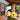 Gardener on farm porch with an armful of yellow Y-star squash