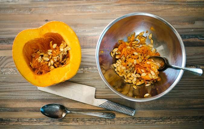 Half a pumpkin, sliced and scooped out into a bowl.