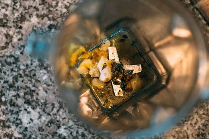 Herbs, spices, and pumpkin in a blender.