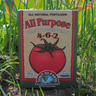 Box of Down to Earth All Purpose Tomato & Vegetable Mix fertilizer in a garden setting
