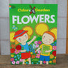 Color & Garden Flowers children's coloring book with bright green illustrated cover, sitting on wooden table.