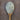White garlic pepper, flecked with black and green inclusions, on a rustic wooden spoon.