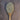Rich yellow and brown lemon pepper on a rustic wooden spoon.