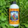 Neptune's Harvest organic fish fertilizer bottle on a healthy green garden background
