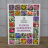 The Old Farmer's Almanac Flower Gardener's Handbook with bright floral cover, set on a wooden table.